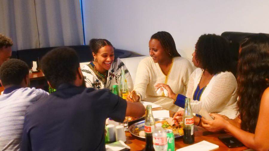 Guests laughing together over a meal at Banna